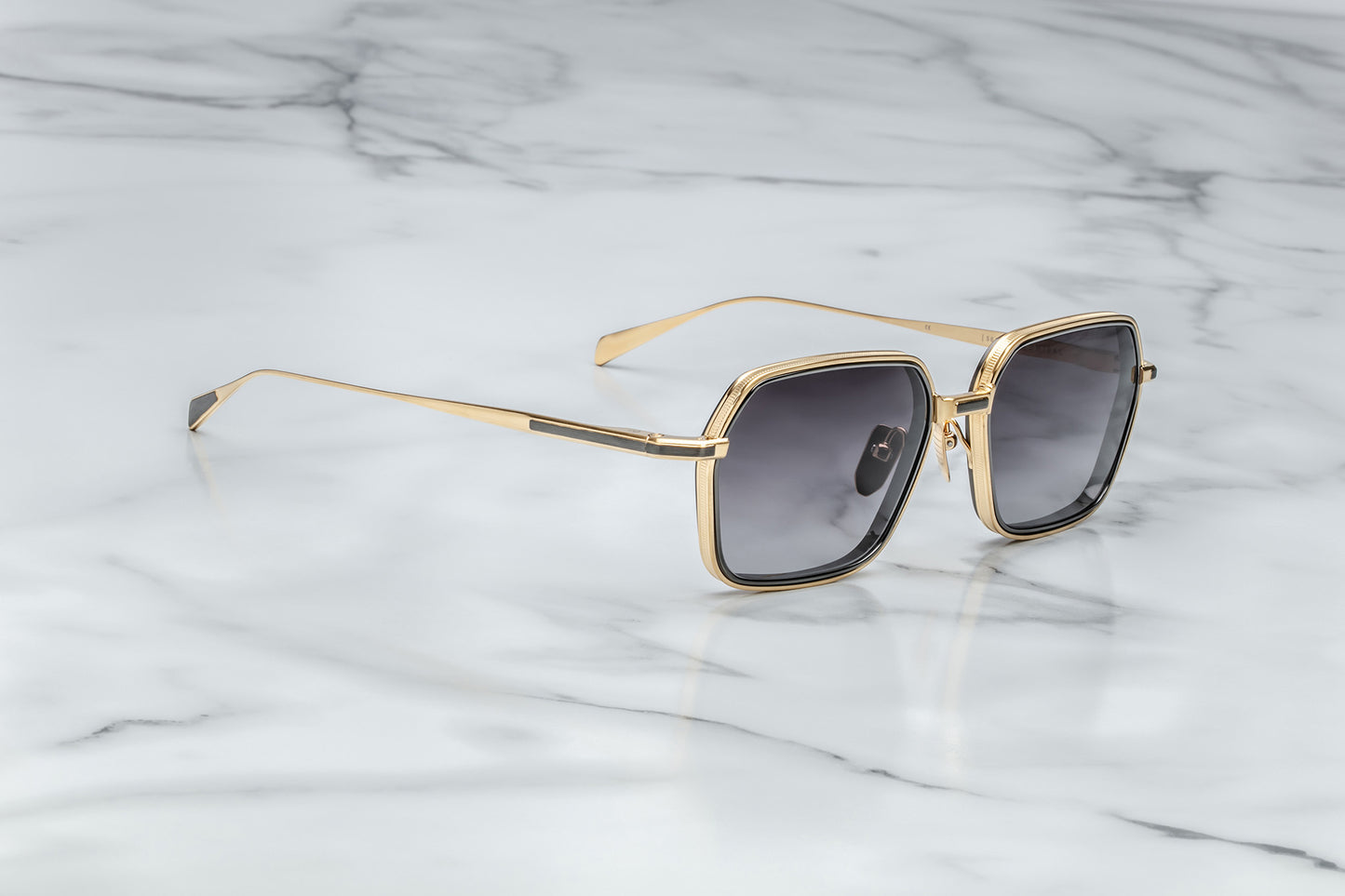 Side view of gold aviator sunglasses with black gradient lenses