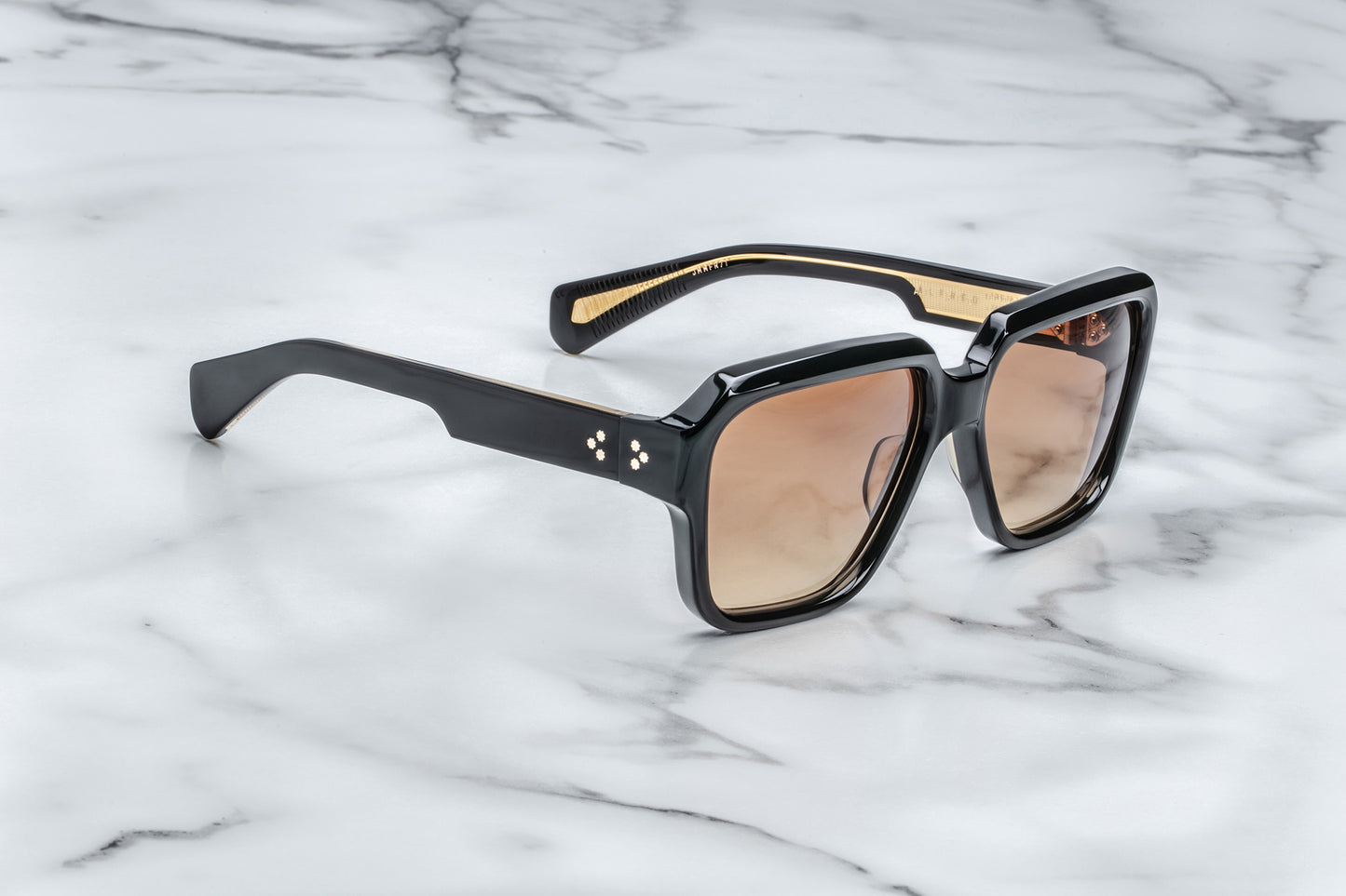 Side view of rounded rectangular black sunglasses with brown lenses