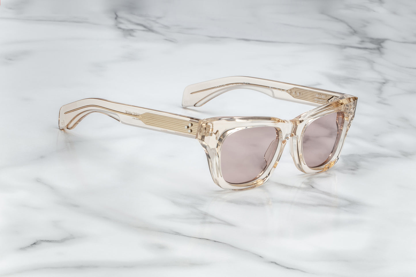 Overhead view of dusty rose translucent rectangular sunglasses with mauve lenses