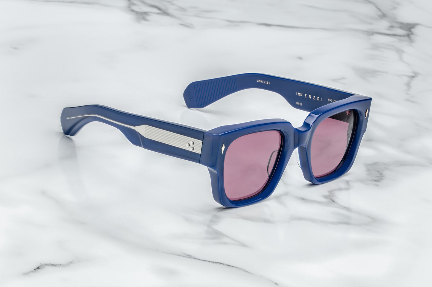 Side view of rectangular royal blue sunglasses with red lenses and silver accents