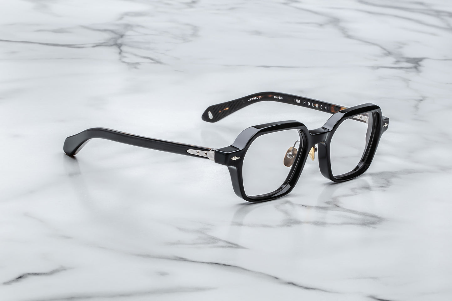 Overhead view of black hexagonal eyeglasses with silver accents
