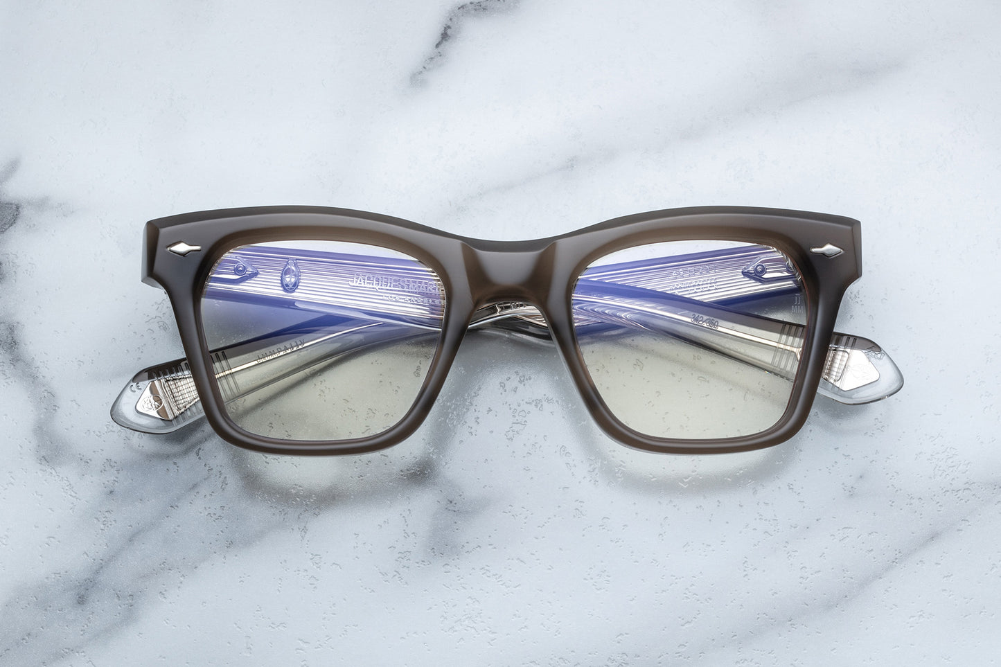 Overhead view of rectangular eyeglasses with brown grey frames and silver accents