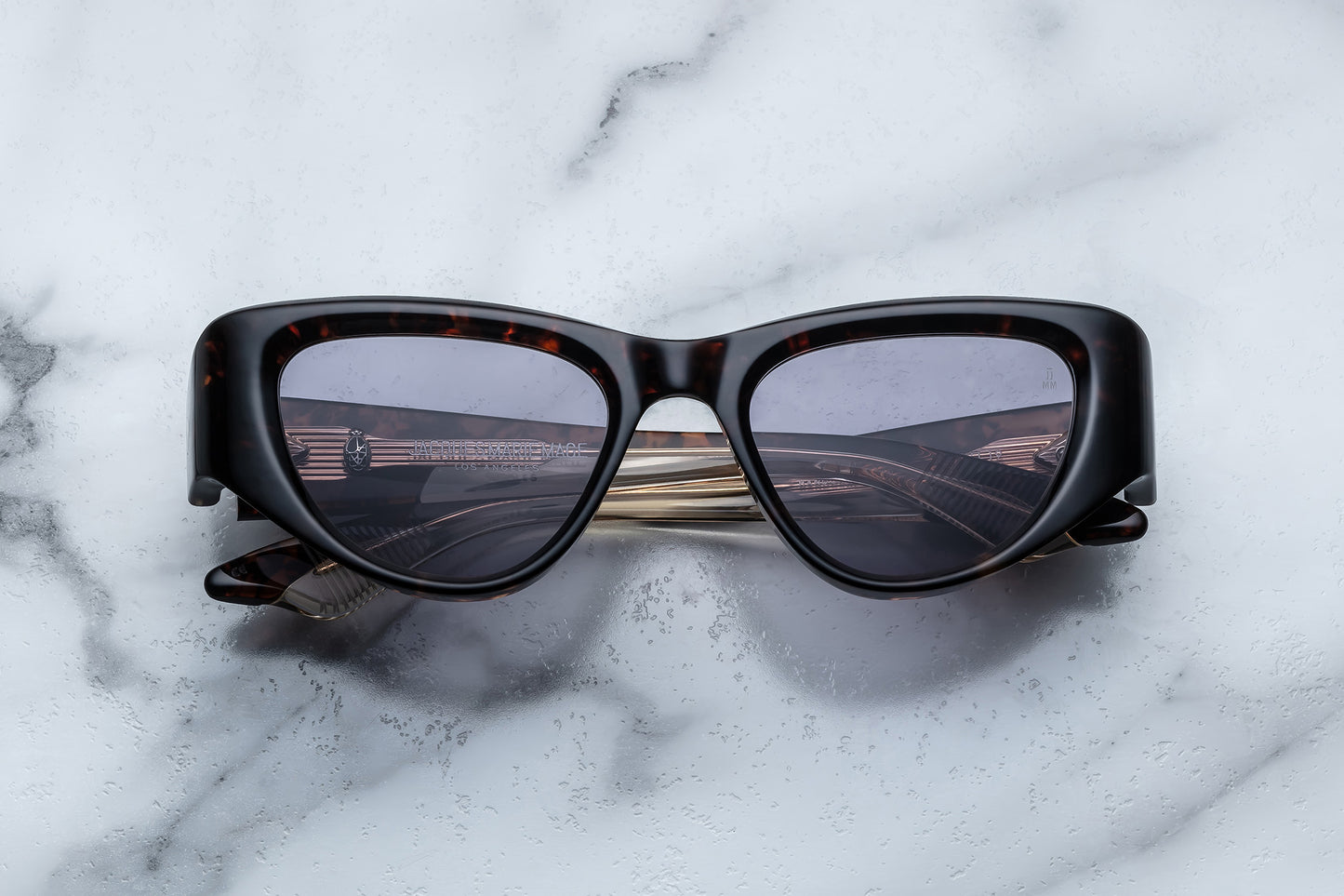 Overhead view of brown cat eye sunglasses with purple lenses