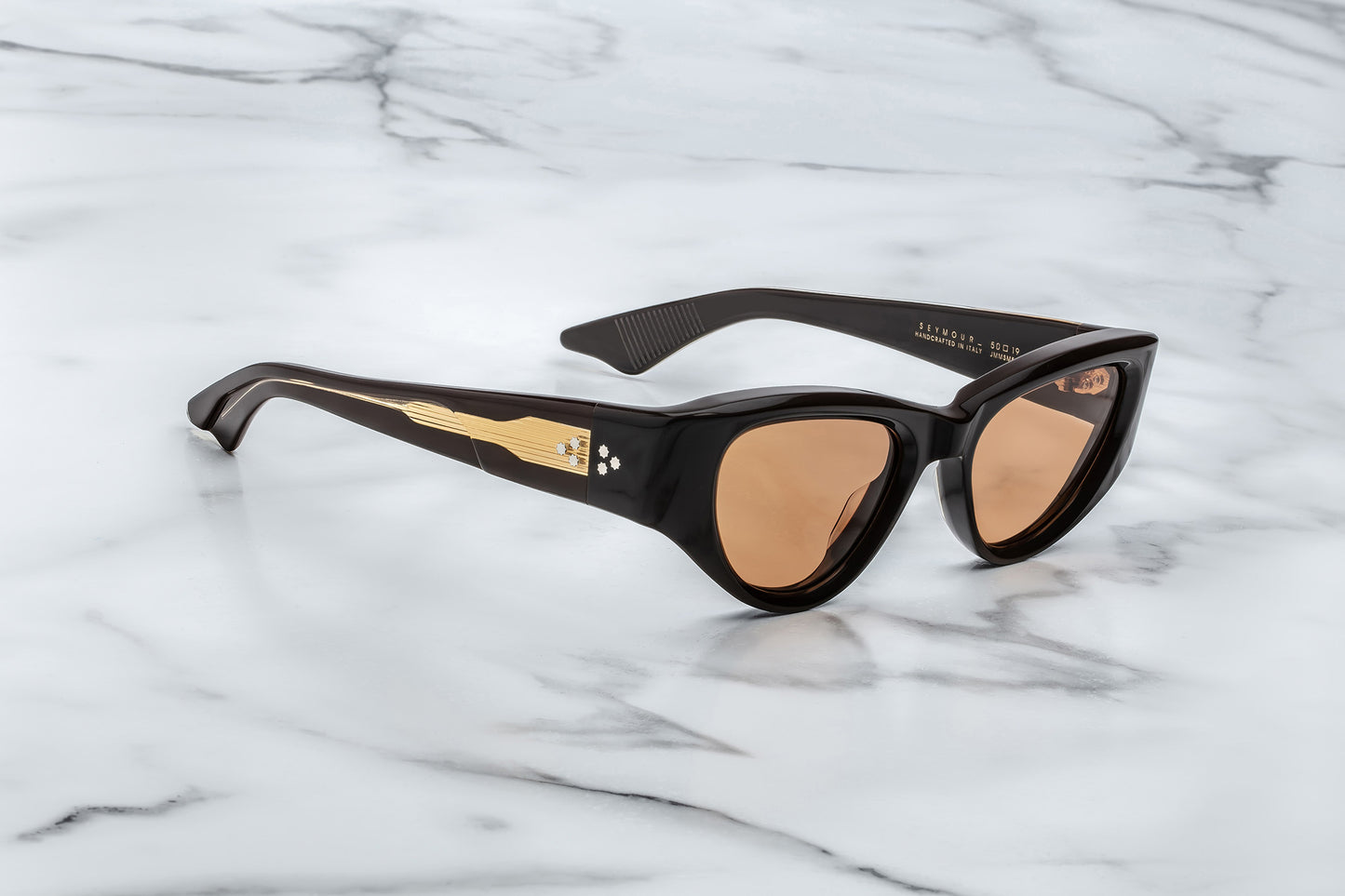Side view of brown cat eye sunglasses with orange lenses