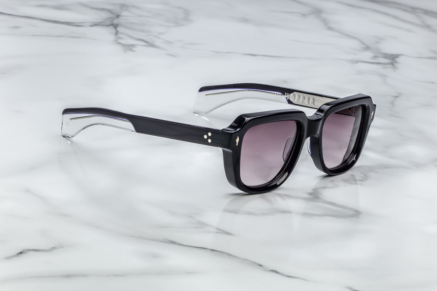 Side view of black sunglasses with purple lenses
