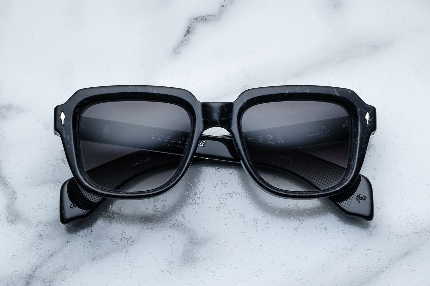 Overhead view of black sunglasses with black lenses