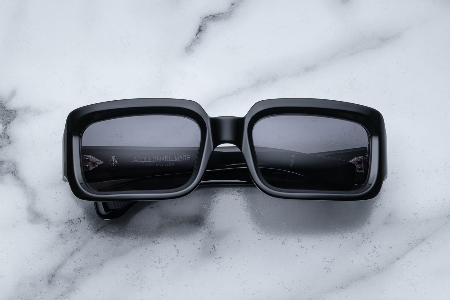 Overhead view of black rectangular sunglasses with black lenses