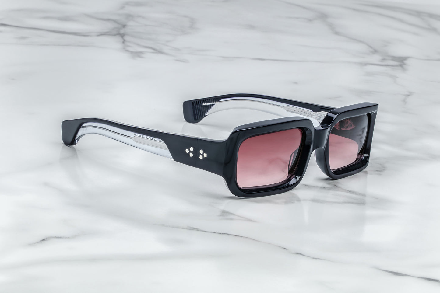 Side view of black rectangular sunglasses with burgundy lenses