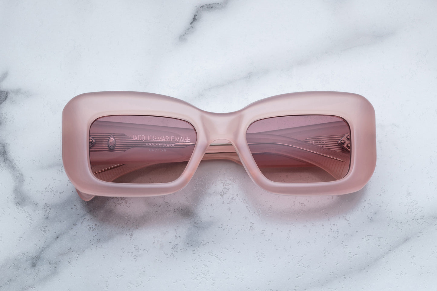 Overhead view of pink sunglasses with pink lenses