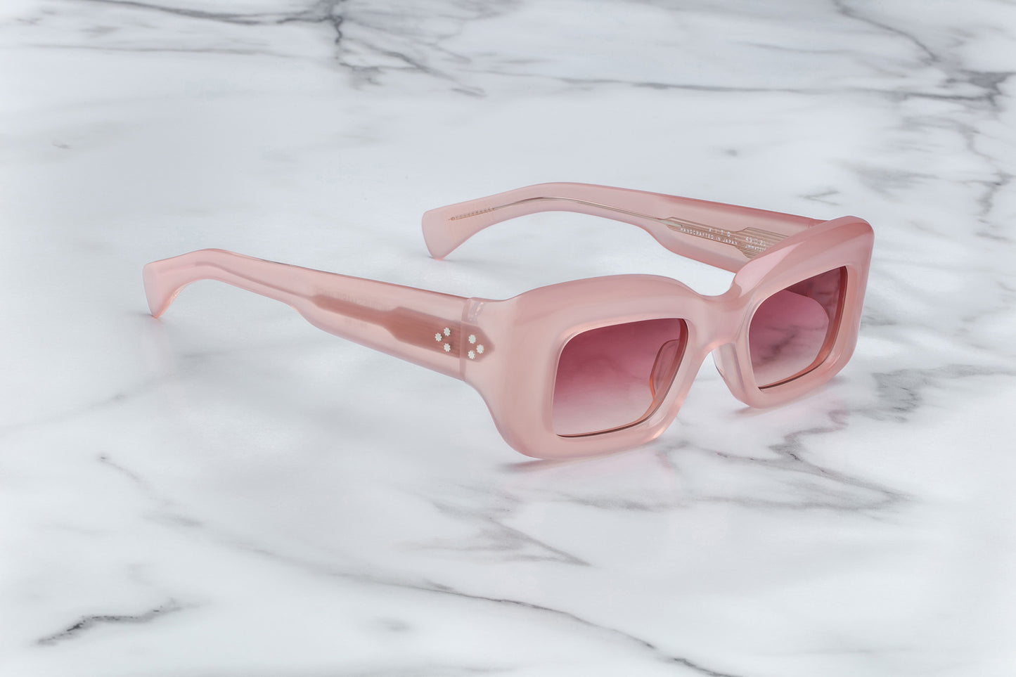 Overhead view of pink sunglasses with pink lenses