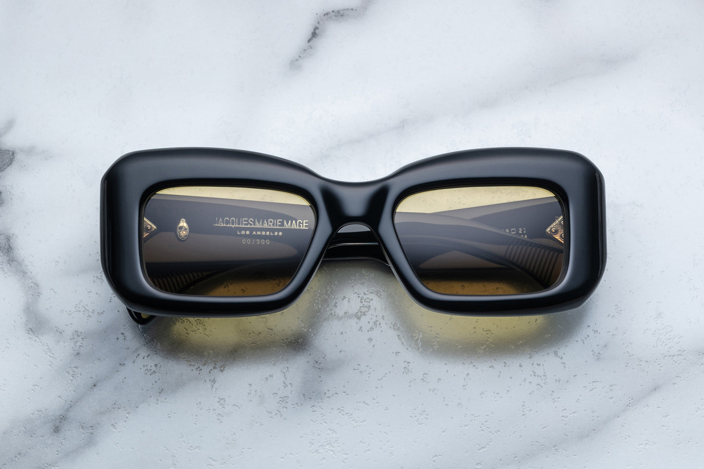 Overhead view of black sunglasses with yellow lenses