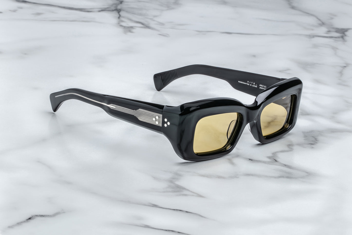 Side view of black sunglasses with yellow lenses