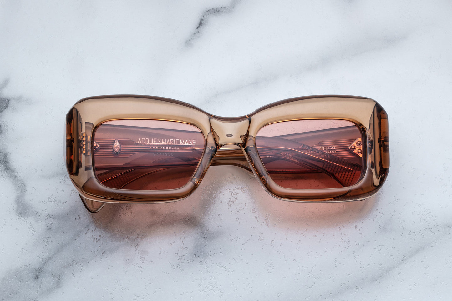 Overhead view of rose translucent sunglasses with pink lenses