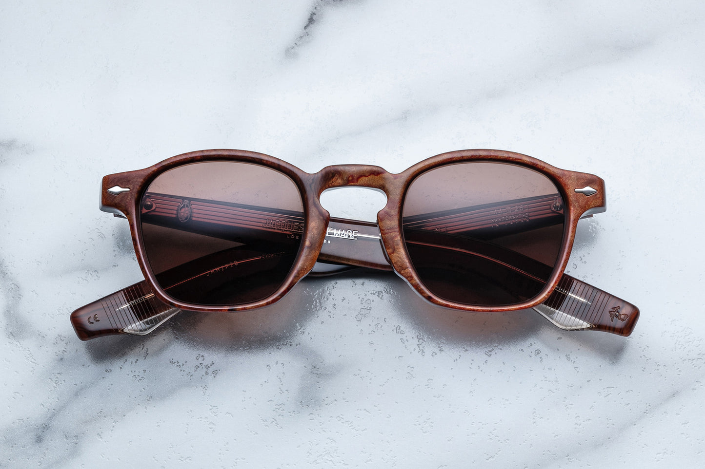Overhead view of brown rounded rectangular sunglasses with brown lenses