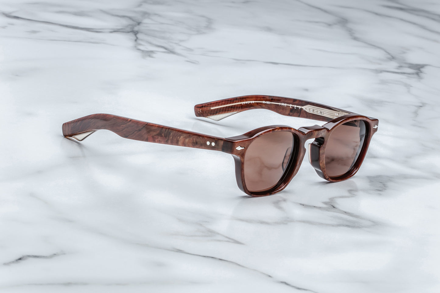 Side view of brown rounded rectangular sunglasses with brown lenses