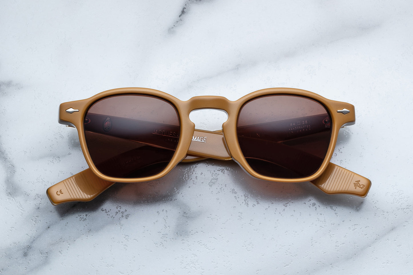 Overhead view of brown mustard rounded rectangular sunglasses with brown lenses