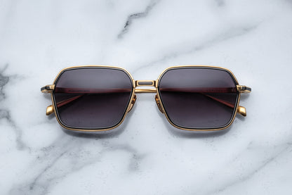 Overhead view of gold aviator sunglasses with black gradient lenses