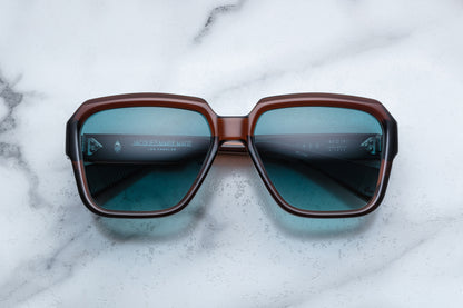 Overhead view of rounded rectangular brown sunglasses with blue lenses