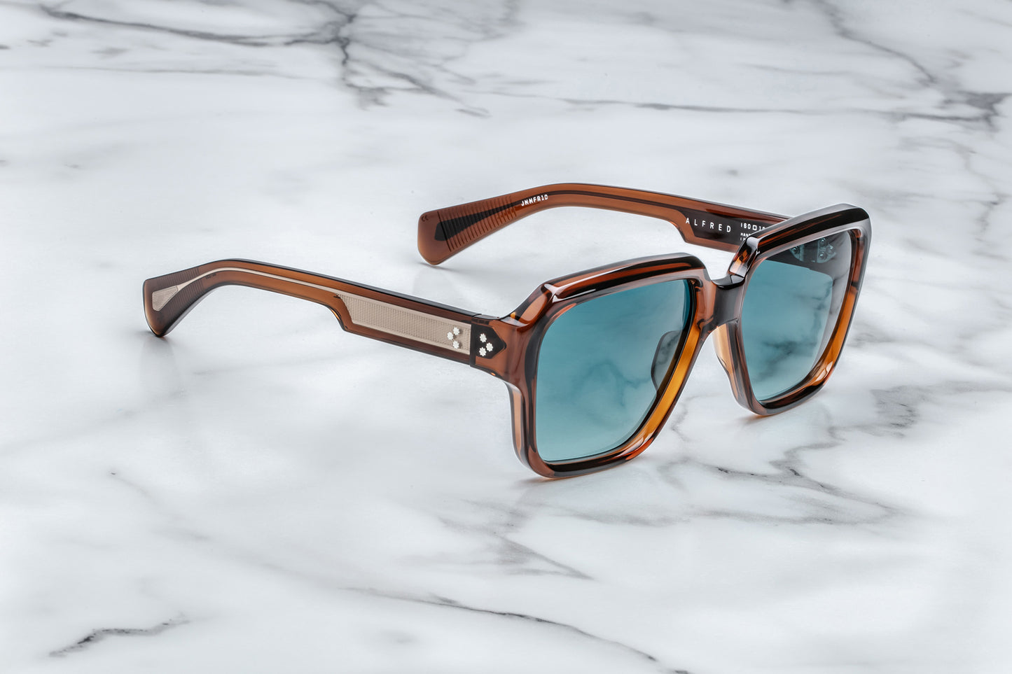 Side view of rounded rectangular brown sunglasses with blue lenses