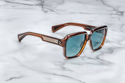 Side view of rounded rectangular brown sunglasses with blue lenses