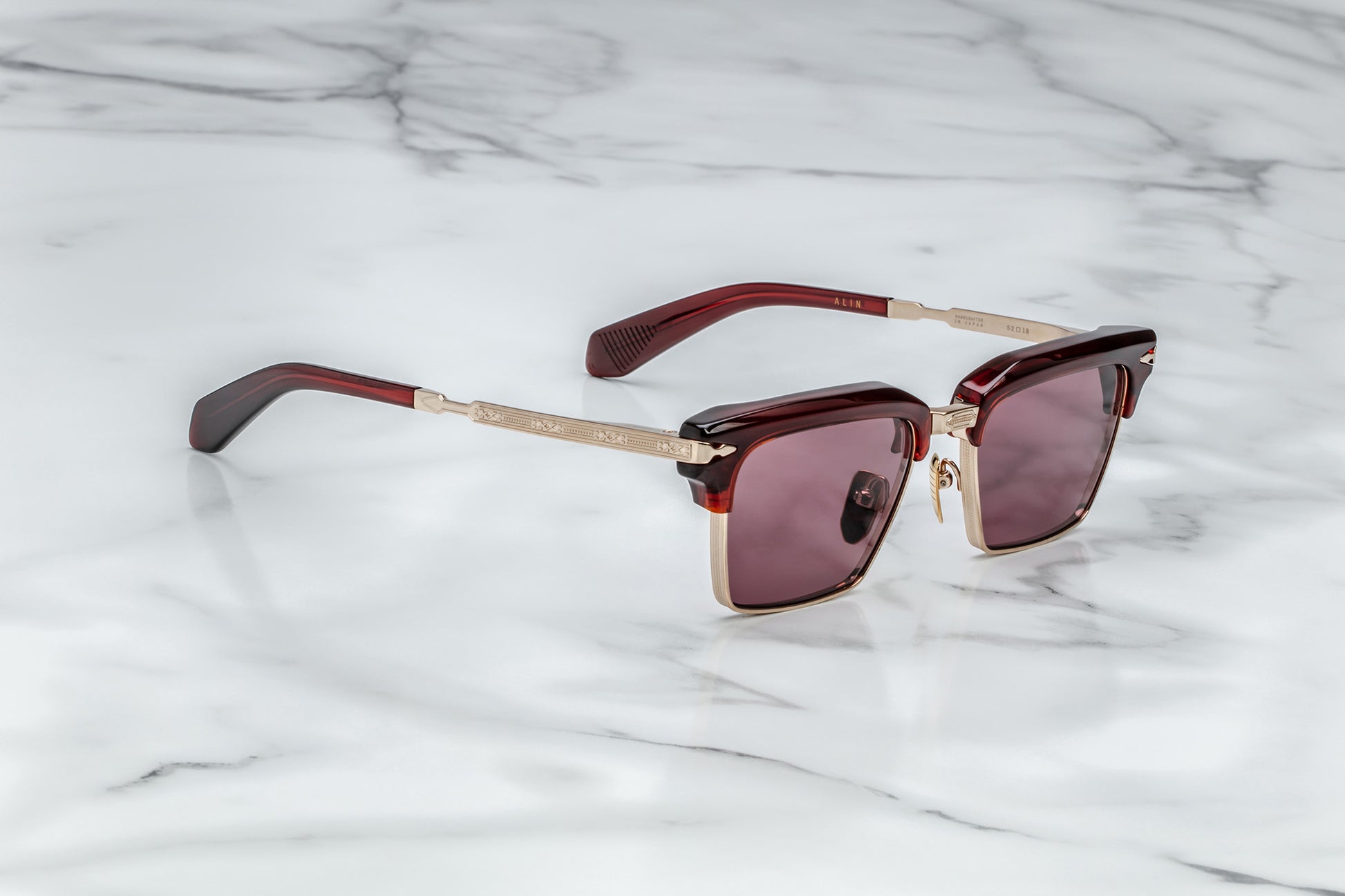 Side view of light gold rectangular sunglasses with red lenses