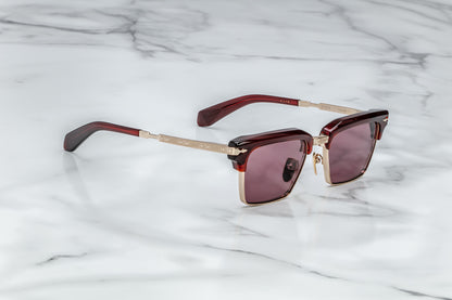 Side view of light gold rectangular sunglasses with red lenses
