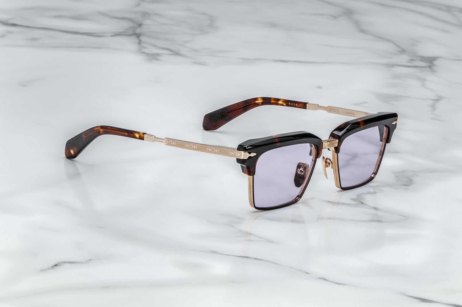 Side view of light gold rectangular sunglasses with lavender lenses