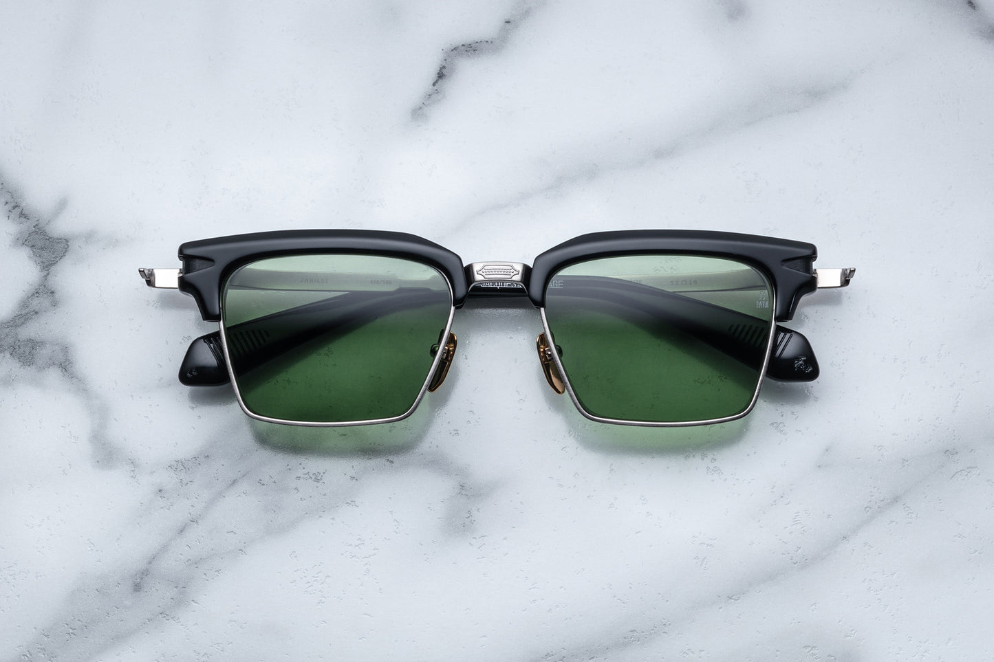 Overhead view of silver rectangular sunglasses with green lenses