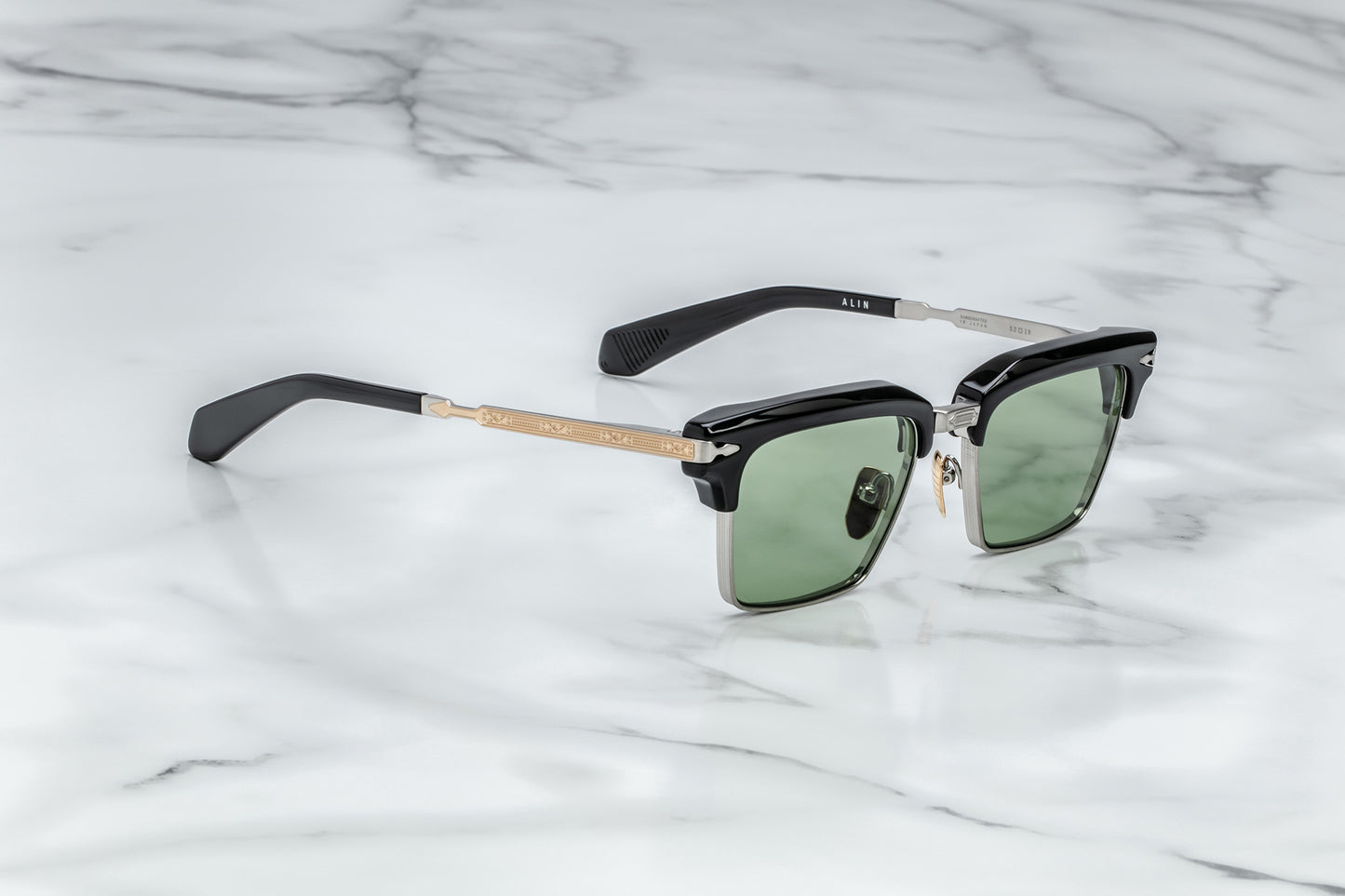 Side view of silver rectangular sunglasses with green lenses