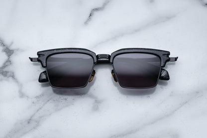Overhead view of black rectangular sunglasses with black lenses