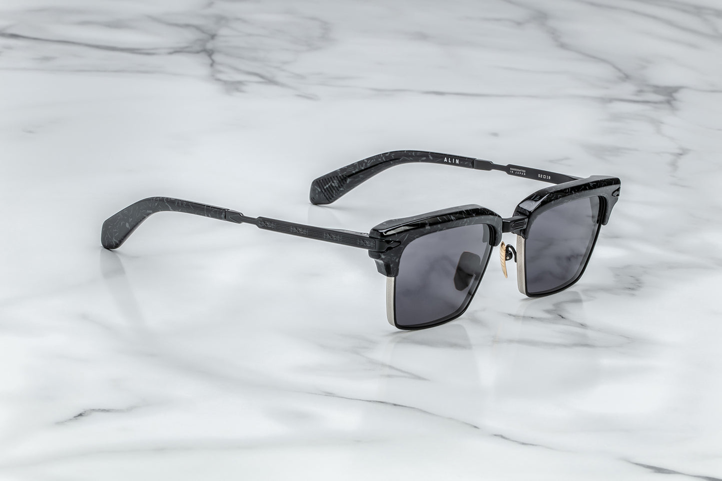 Overhead view of black rectangular sunglasses with black lenses