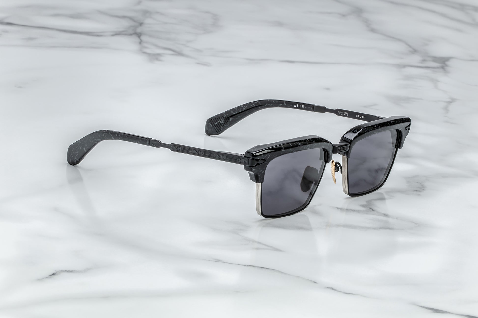 Overhead view of black rectangular sunglasses with black lenses