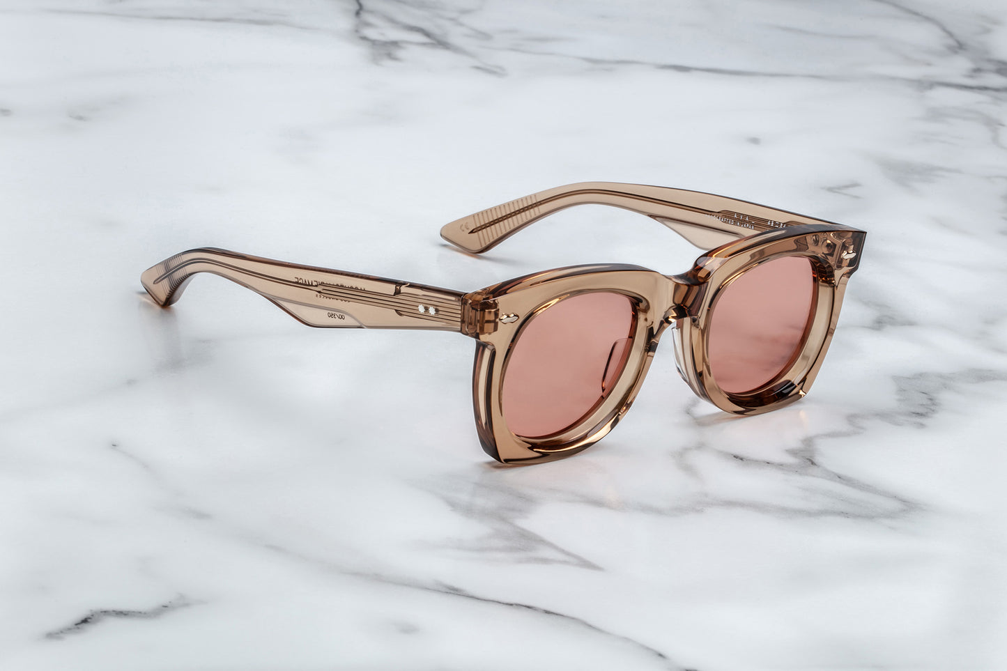 Side view of tan translucent sunglasses with pink lenses