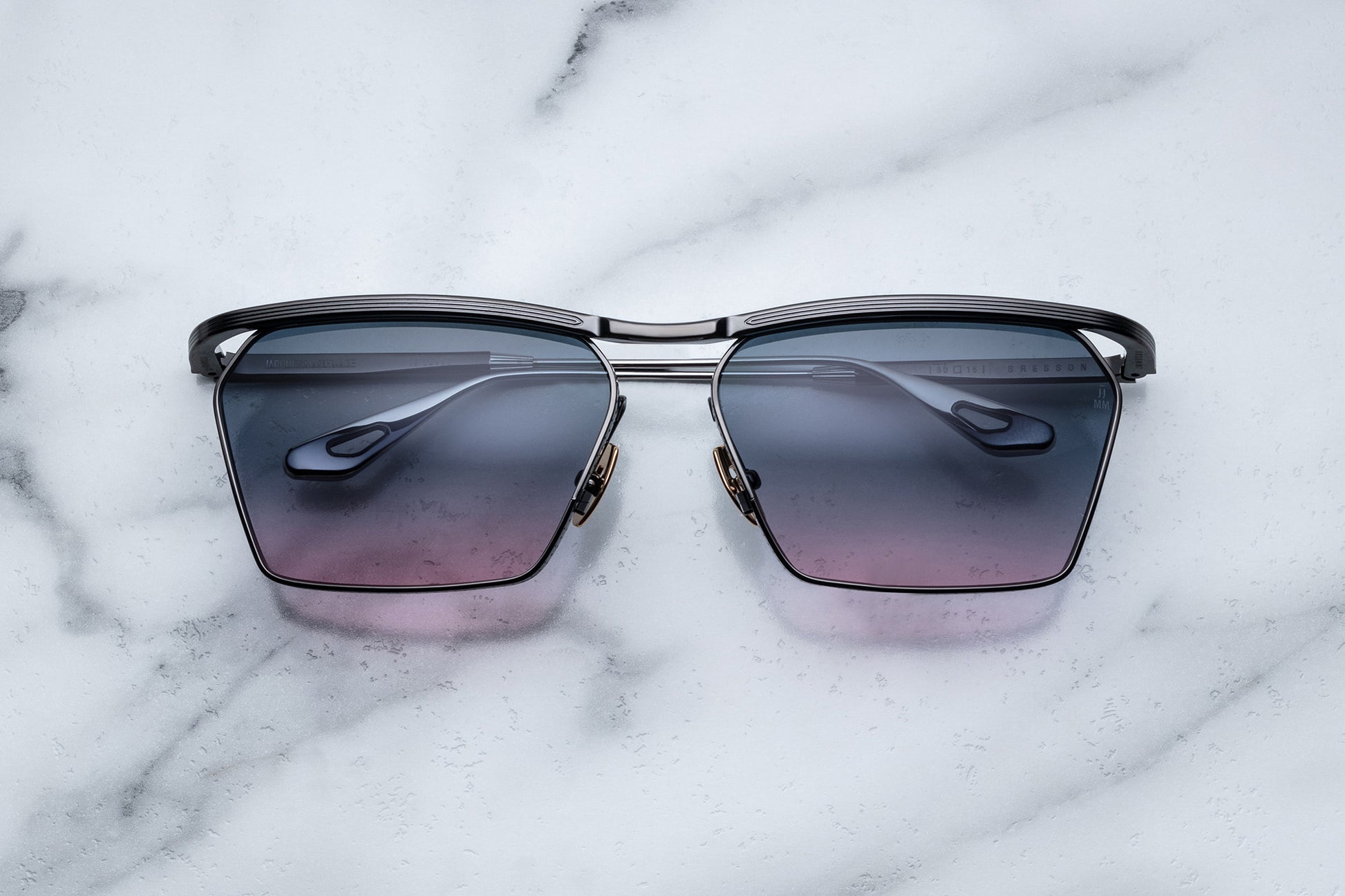 Overhead view of black sunglasses purple gradient lenses