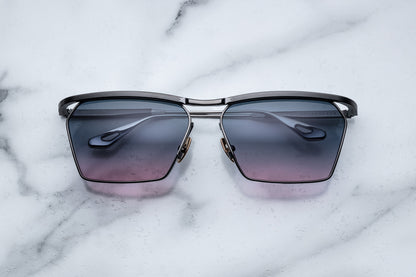 Overhead view of black sunglasses purple gradient lenses