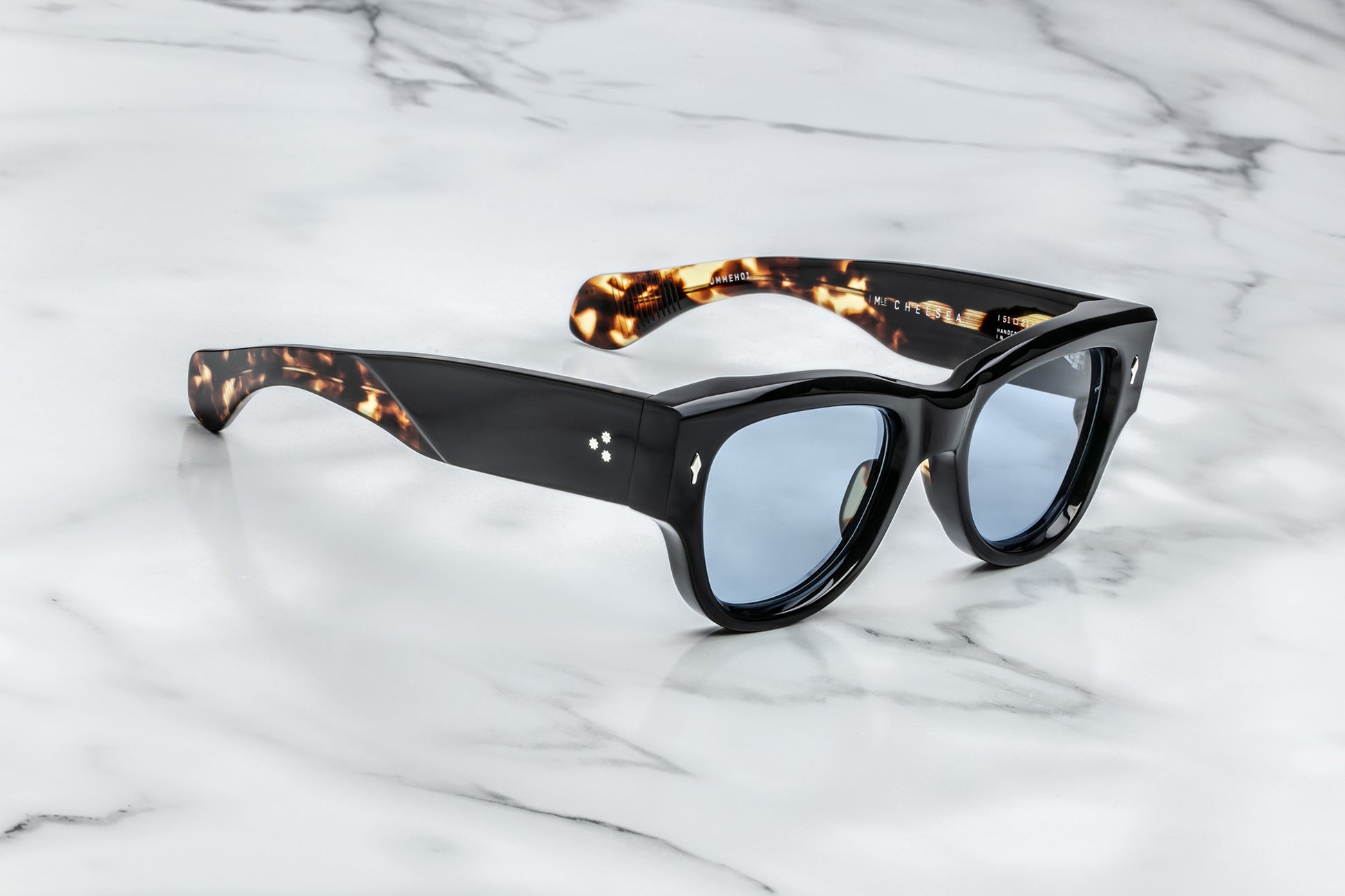 Side view of black sunglasses with blue lenses