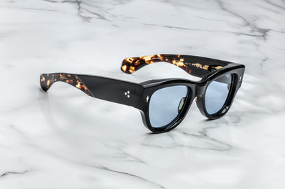 Side view of black sunglasses with blue lenses