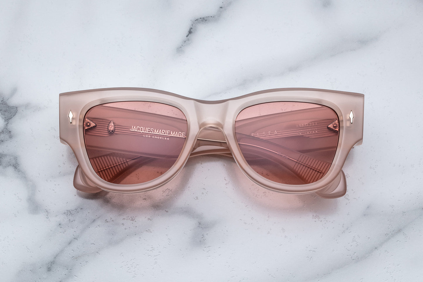 Overhead view of quartz pink sunglasses with light pink lenses
