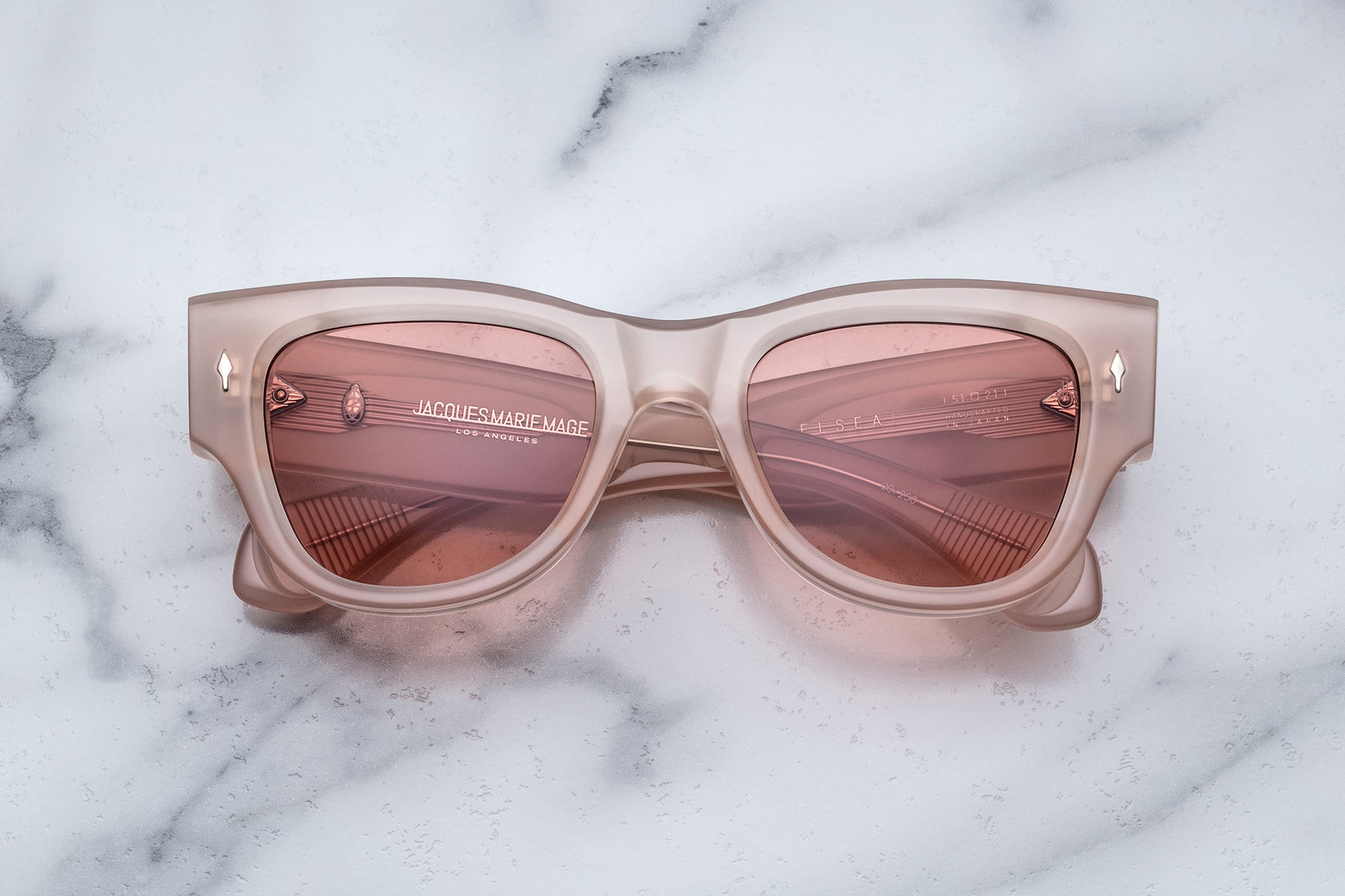 Overhead view of quartz pink sunglasses with light pink lenses