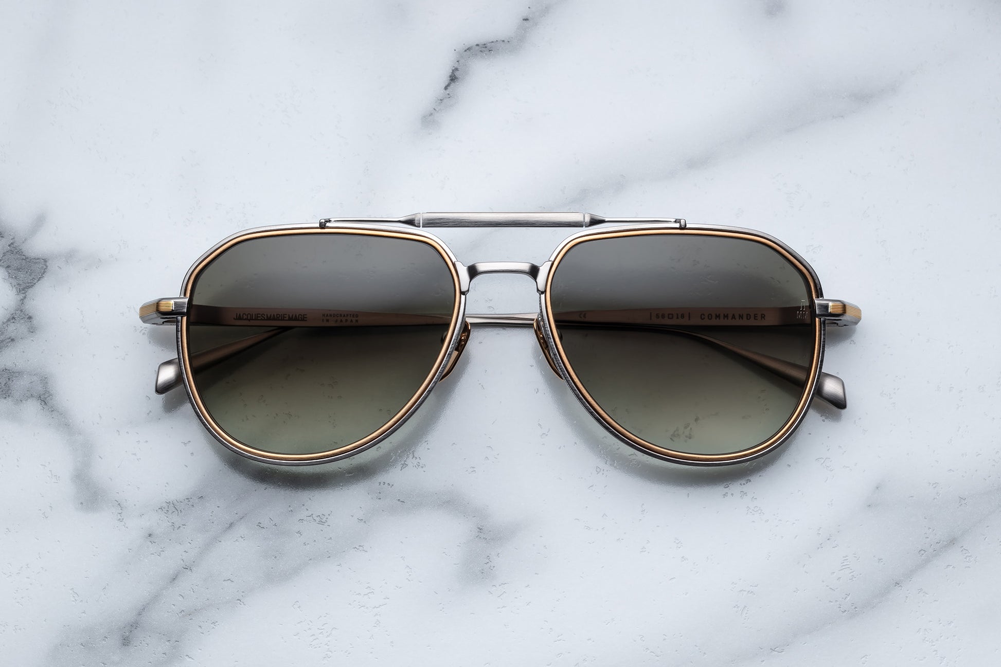 Overhead view of silver and gold aviator sunglasses with light green lenses