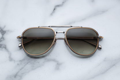 Overhead view of silver and gold aviator sunglasses with light green lenses