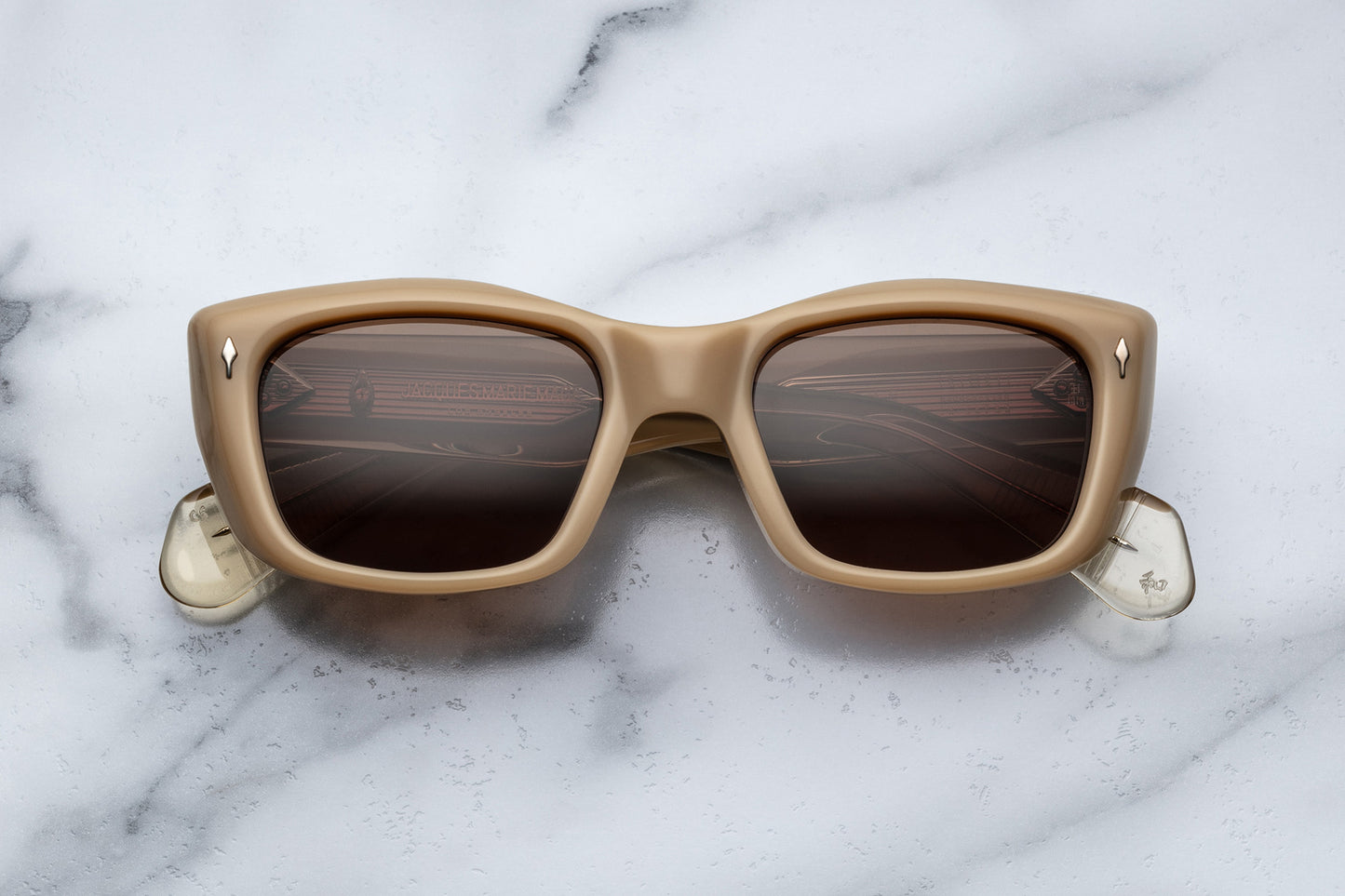 Overhead view of beige cat eye sunglasses with brown lenses