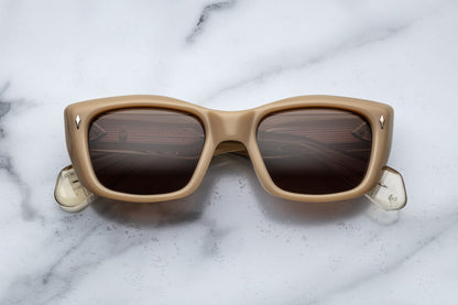 Overhead view of beige cat eye sunglasses with brown lenses