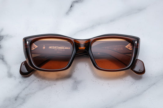 Overhead view of translucent tan  cat eye sunglasses with orange lenses