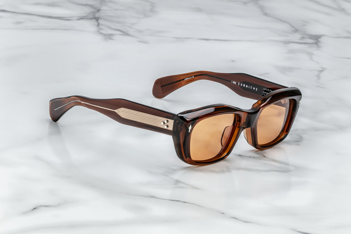 Profile view of translucent tan  cat eye sunglasses with orange lenses