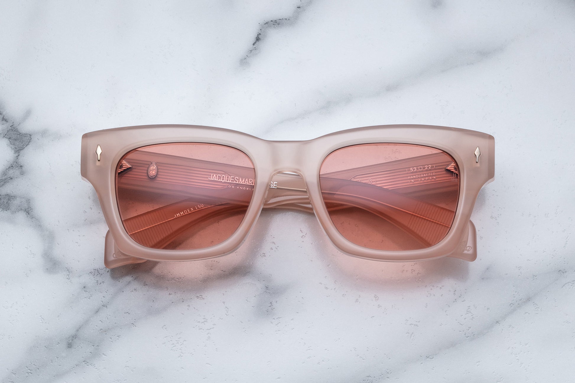 Overhead view of light pink sunglasses
