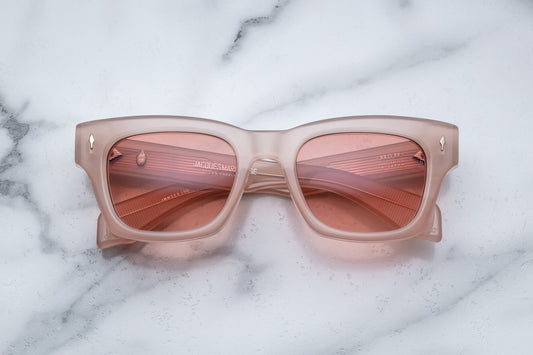 Overhead view of light pink sunglasses