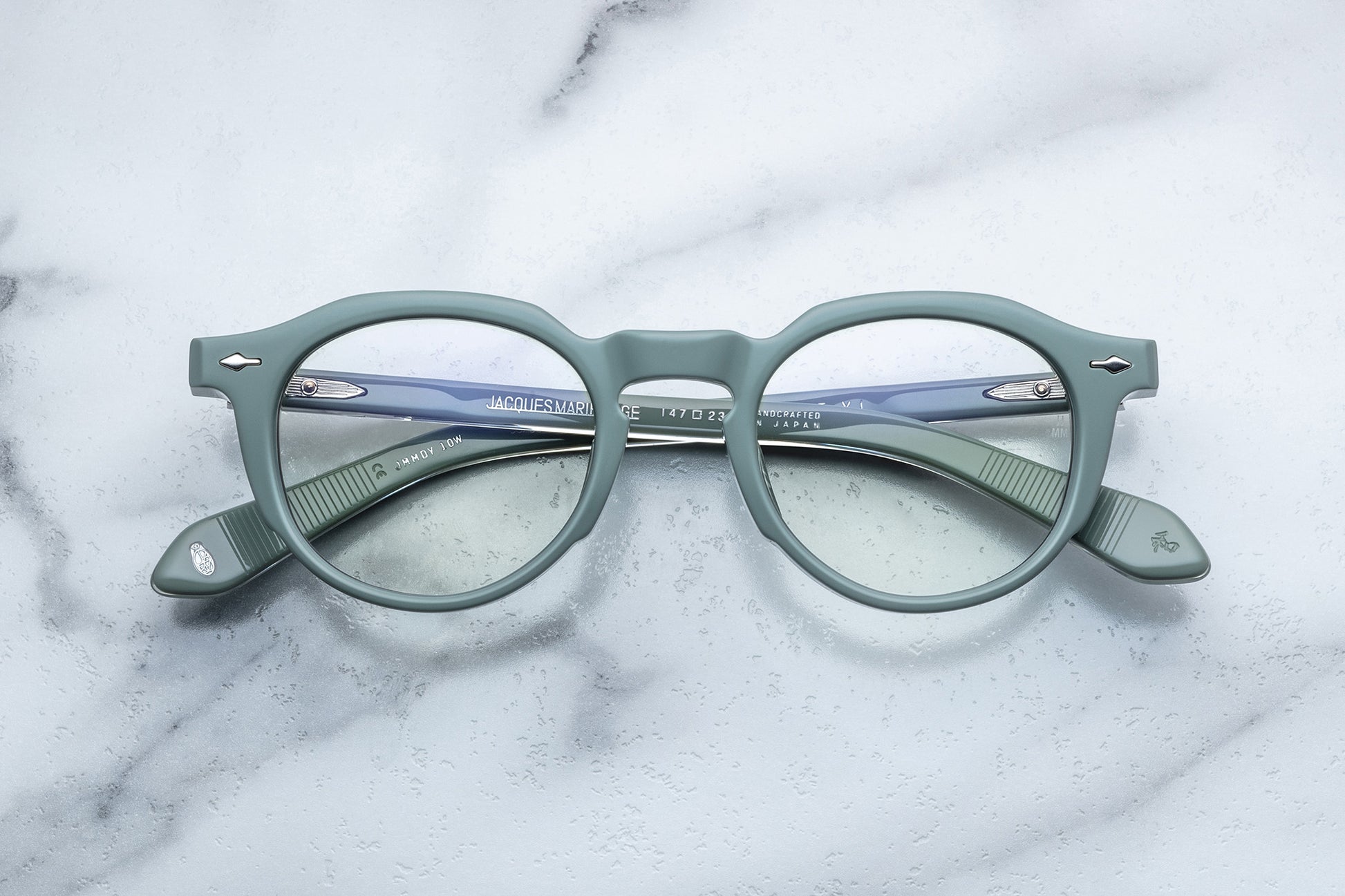 Overhead view of powder blue round eyeglasses with silver accents