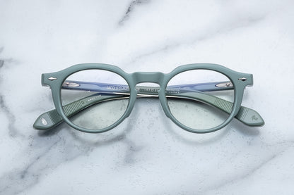 Overhead view of powder blue round eyeglasses with silver accents