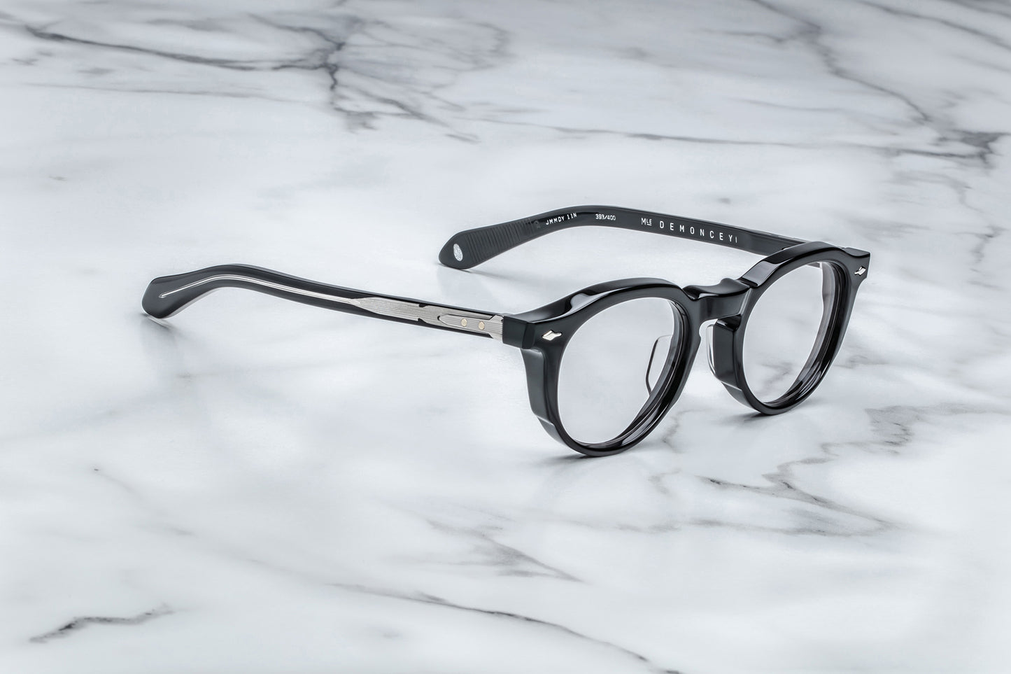 Side view of black round eyeglasses with silver accents